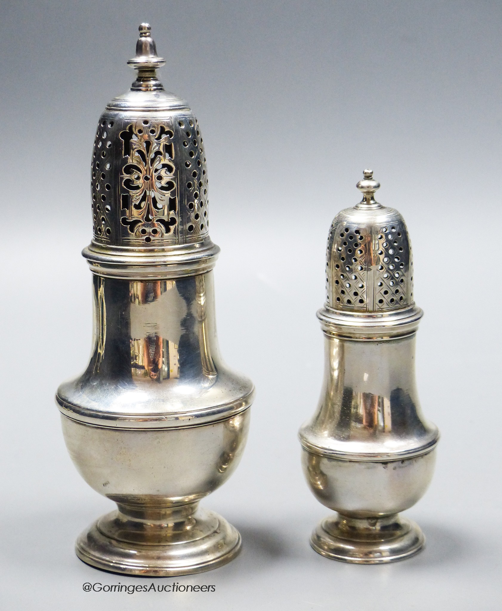 A George II silver baluster sugar caster, Samuel Wood, London, 1747, 61.2cm an earlier silver pepperette, London, 1734, 11.7cm, 8oz.